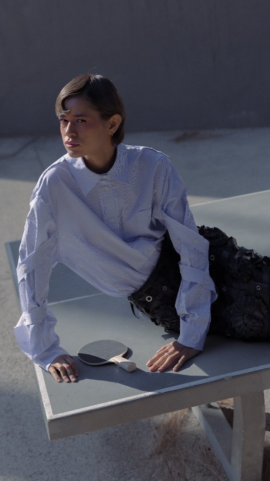 ModaLisboa Priority campaign: posing on a concrete ping-pong table in a striped shirt